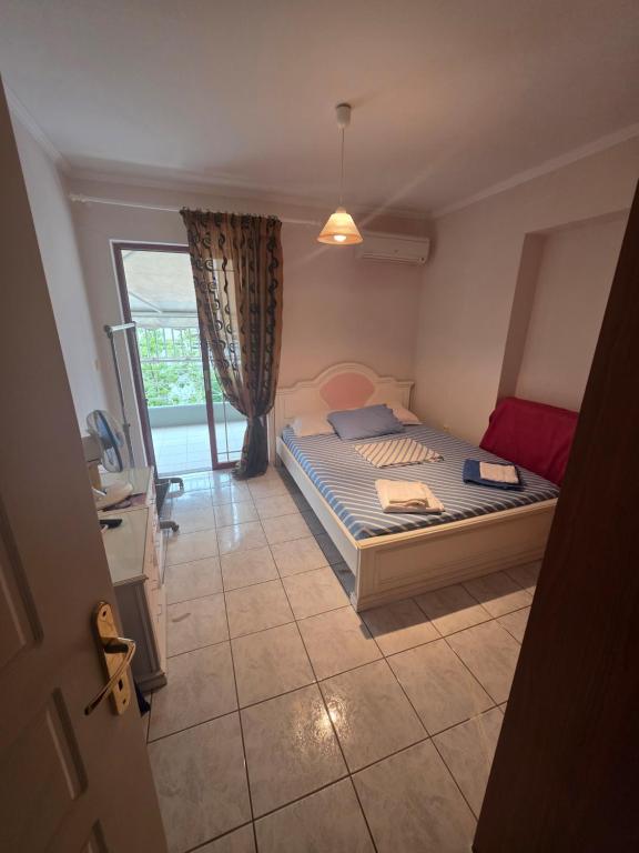 a bedroom with a bed and a large window at Ariadni's Dreamhouse in Akrata