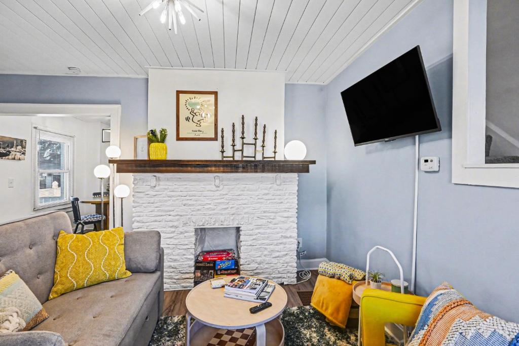 a living room with a couch and a fireplace at Luxe 2BR Franklinton - Private Patio - 2Car Garage in Columbus