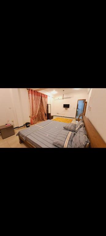 a room with a large bed in the middle of it at Imperial Royal Grand Hotel in Wennawatta