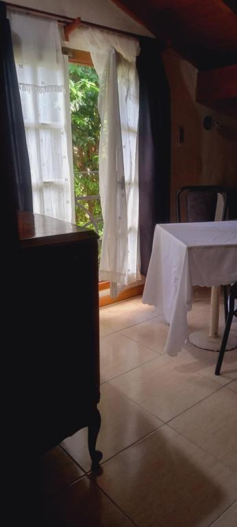a table in a room with a white table cloth at Habitaciones Cecy in General Juan Madariaga