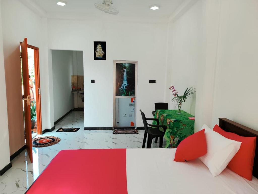 a bedroom with a bed and a dining room at OCEAN Wild Trail in Hikkaduwa