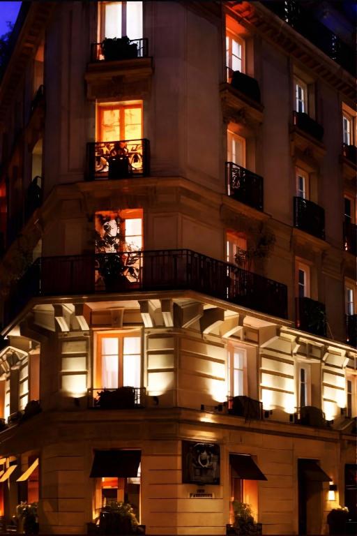 a building with lit windows and balconies at night at Hotel Zava Boutique - City Center in Bucharest