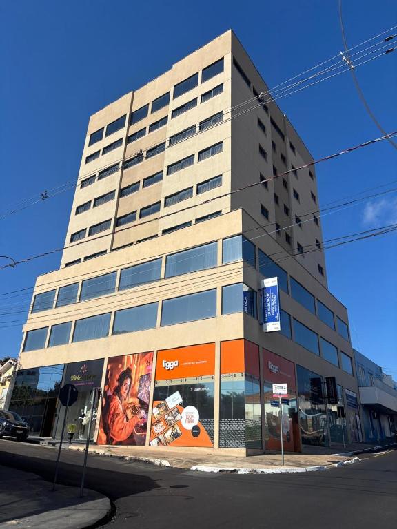 a tall building with an advertisement on the side of it at Hotel Canta Galo Tower in Jacarèzinho