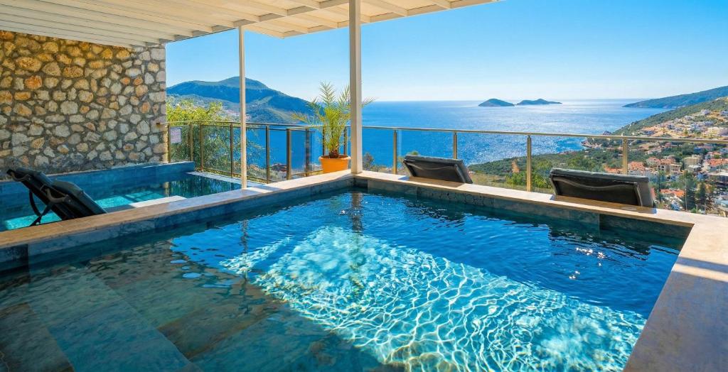a swimming pool with a view of the ocean at Villa Sheyma in Kalkan