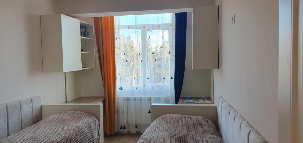 a living room with two chairs and a window at Moreni house in Gavarr