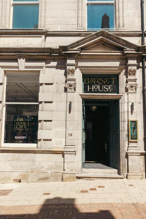 a facade of a building with a barber house at Barnet House Serviced Apartments in Dunfermline