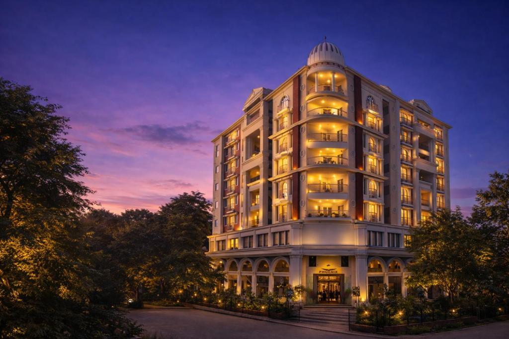 a large white building with lights on at Phoenix Unmatched Comfort - Hotel Near Fateh Sagar Lake Udaipur in Udaipur