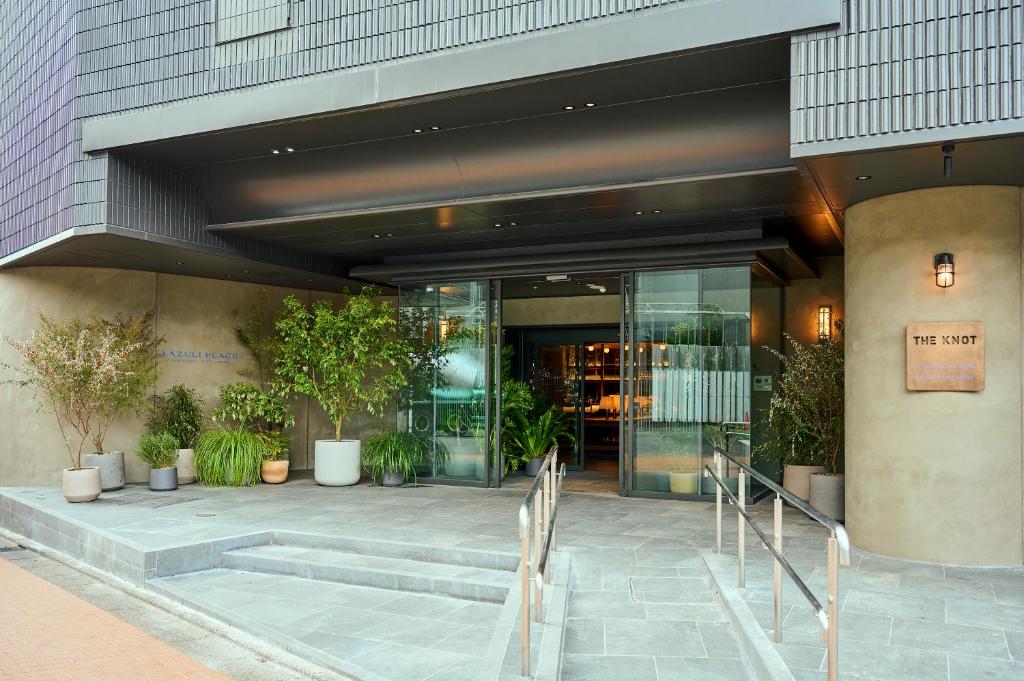 a lobby of a building with stairs and plants at The Knot Utsunomiya in Utsunomiya