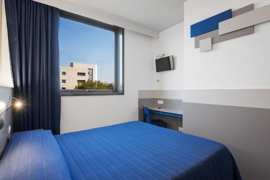 Postel nebo postele na pokoji v ubytování Hotel Martini