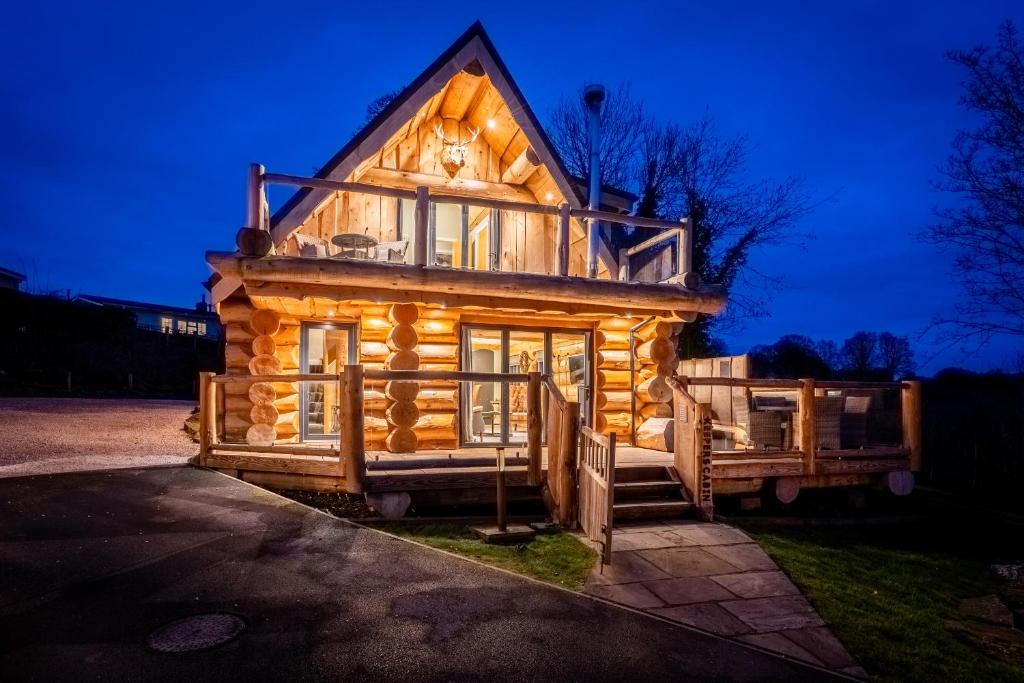 a log cabin with a porch and a large window at Keepers Cabin in Ilkley