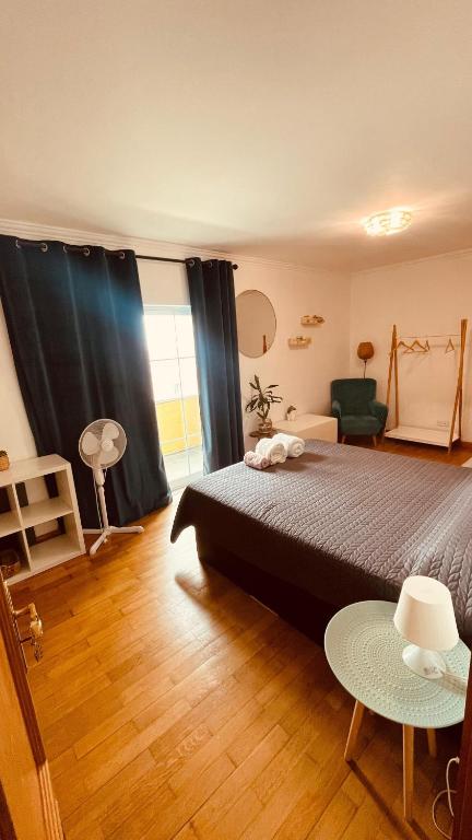 a bedroom with a bed and a window and a table at The Throne in Alcabideche