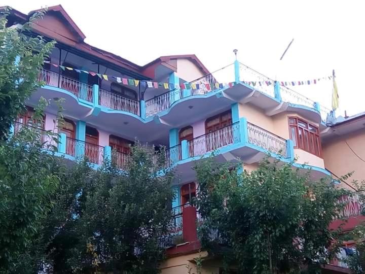 a large building with balconies on the side of it at Hotel Kailash View, Kalpa in Kalpa