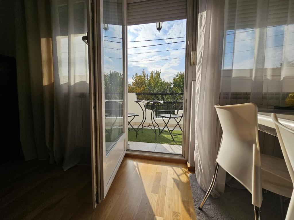 a room with a window and a table and a chair at Airport Apartment in Surčin