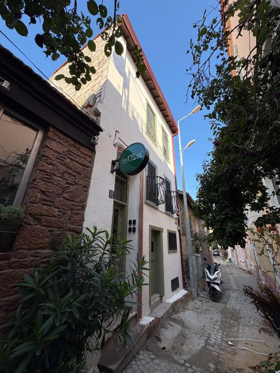 a building with a sign on the side of it at Macaron The Pure Guest Houses in Ayvalık