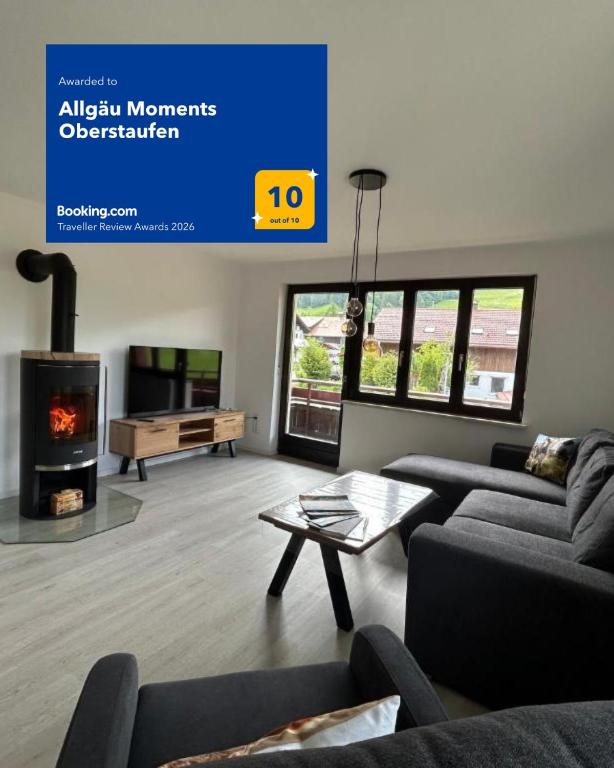 a living room with a couch and a fireplace at Allgäu Moments Oberstaufen in Oberstaufen