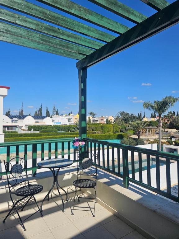 a patio with chairs and a table on a balcony at Quiet 61 Perivolia in Meneou