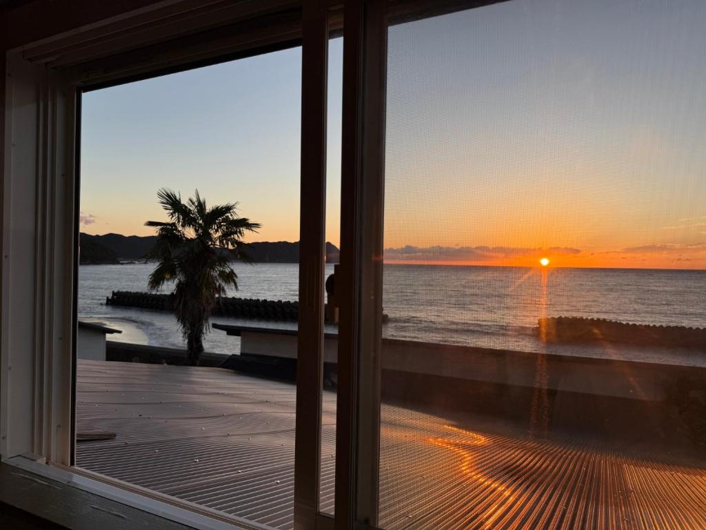 a view of the ocean from a room with a window at Pavilion Beachfront in Shishikui