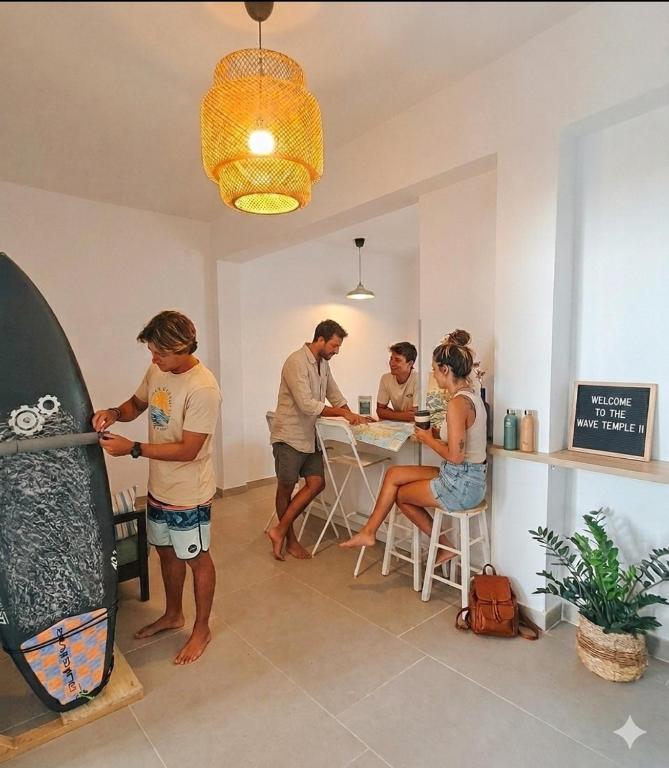 a group of people standing in a room with a surfboard at The Wave Temple II in Las Palmas de Gran Canaria
