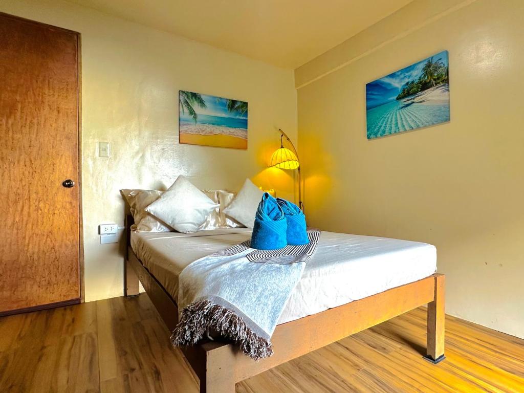 a bedroom with a bed with a blue bag on it at El Nido's View in El Nido