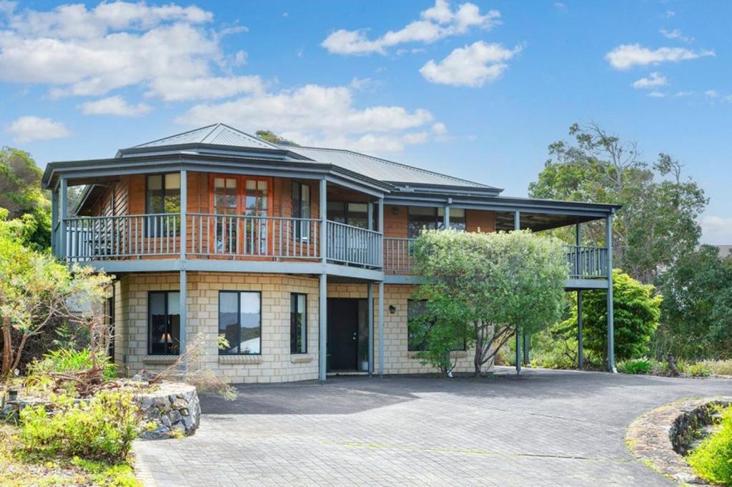 a large house with a balcony on a driveway at Waterside View in Augusta