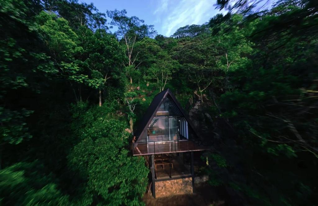 an overhead view of a tree house in the forest at Misty Knuckles Cabana in Rangala