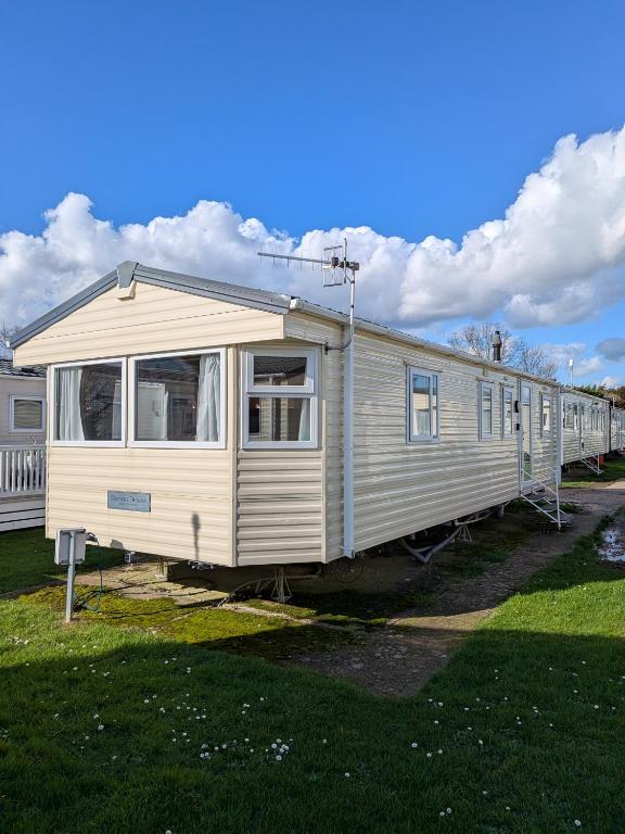 a white train is parked in a yard at Stay static Hayling island holiday park in South Hayling