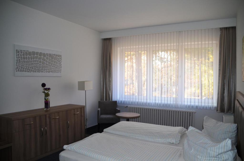 Postel nebo postele na pokoji v ubytování Gästehaus Pauline
