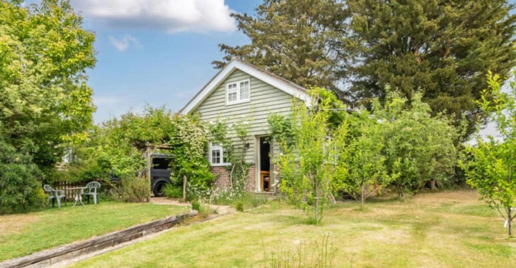 a small house with a bench in the yard at Cosy stay within South Downs! in Southampton