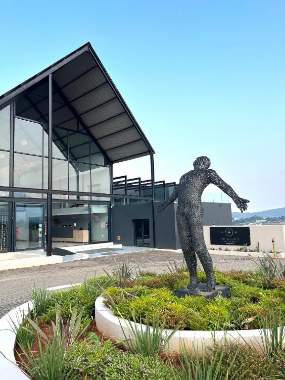 a statue of a man on a skateboard in front of a building at The Legacy Hotel and Spa in Tzaneen