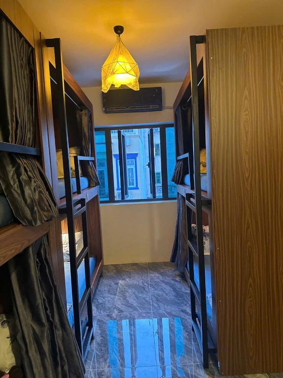 a room with a hallway with shelves and a light at Heaven Hostel in Ho Chi Minh City