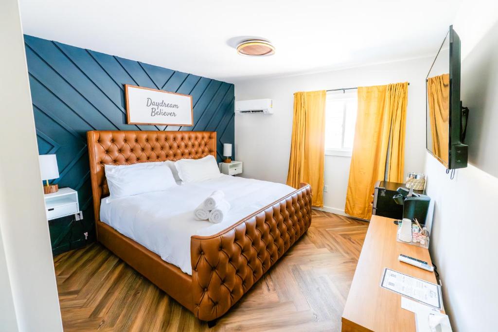 a bedroom with a large bed with a blue wall at Chalet 239-Boutique Hotel in West Dover