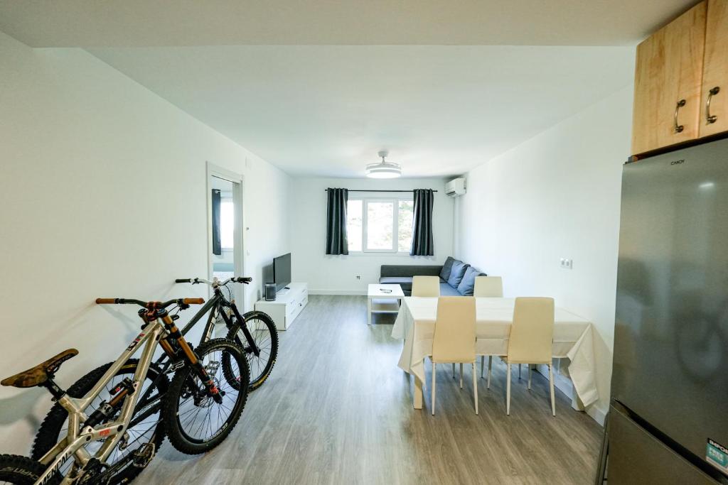 a kitchen and dining room with bikes parked in a room at Mountain Home in La Pinilla