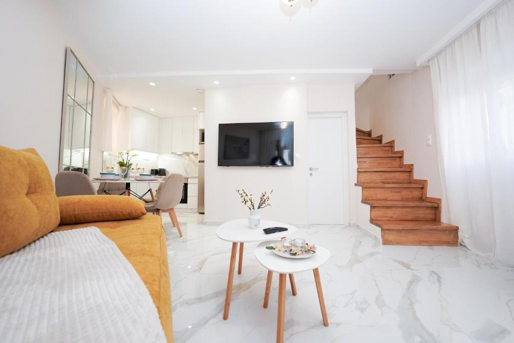 a living room with a couch and a table at Pearl Port House in Ágios Rókkos