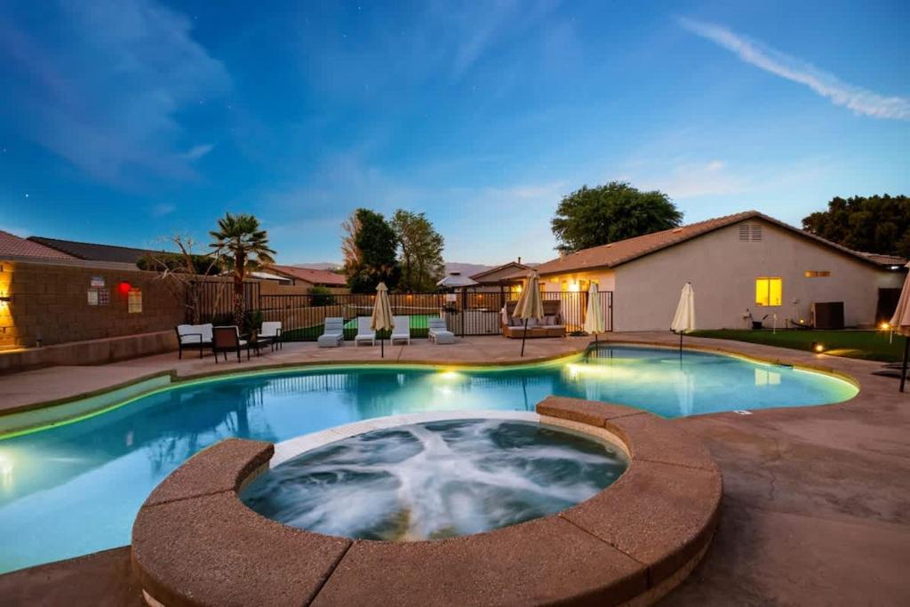 a swimming pool in a yard with a house at Desert Escape - Private Pool - Spa in Indio