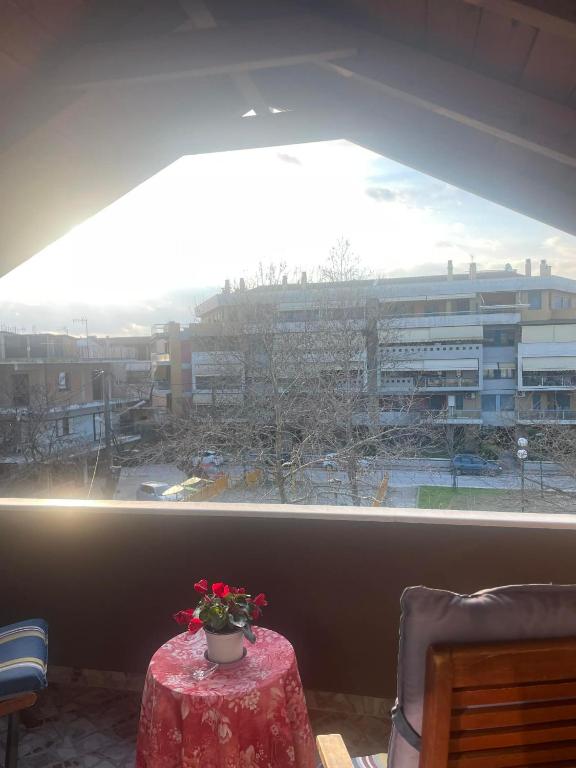 a room with a table and a window with a view at Chaido's attic in Larisa