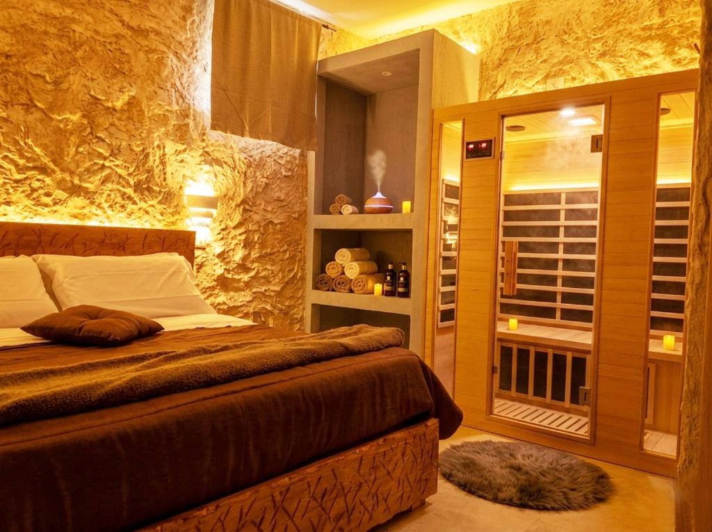 a bedroom with a large bed and a window at suite pompei La Caverna in Pompei