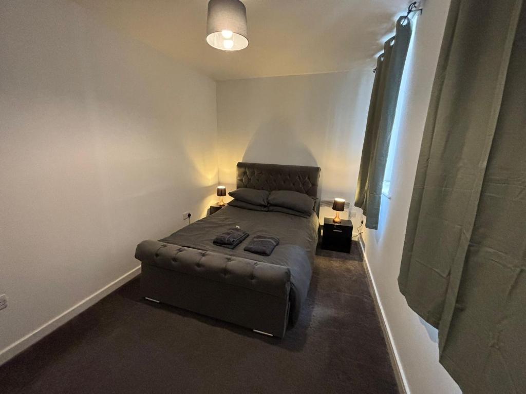 a bedroom with a bed and a couch in a room at Doncaster City Centre Immaculate 1 Bedroom flat in Doncaster