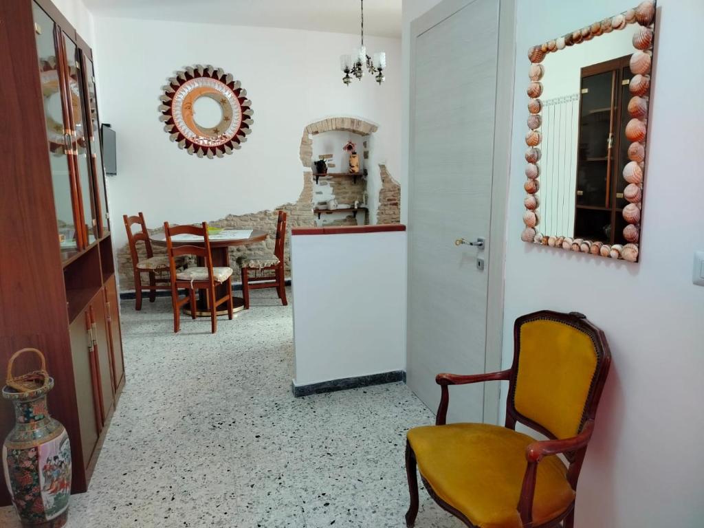 a kitchen with a chair and a mirror and a table at L'antica Terrazzella in Vasto