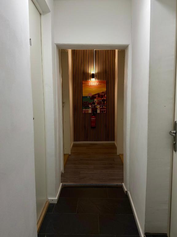 a hallway leading to a door in a building at SleepandGo in Zurich