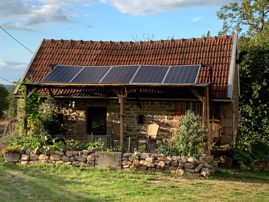 a house with solar panels on the roof at Gîte ABMA in Clugnat