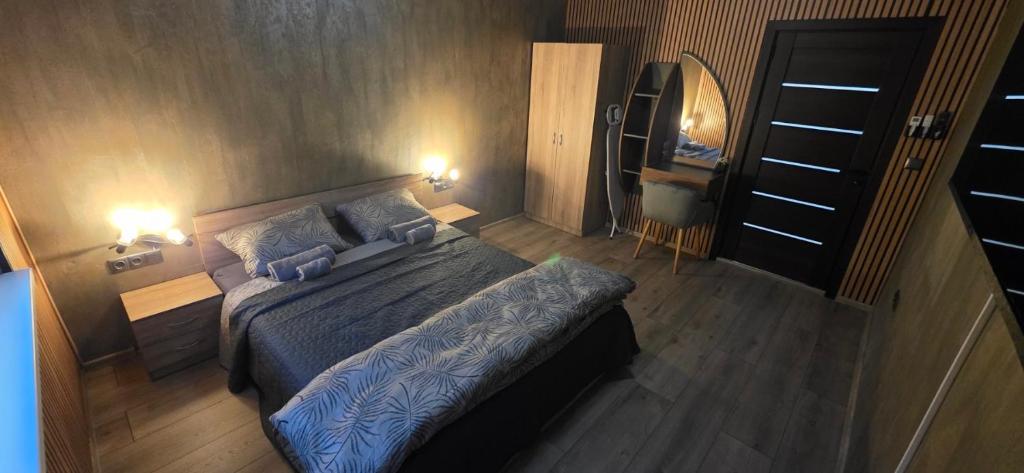 a bedroom with a bed and two blue pillows at Еви 1 in Gabrovo