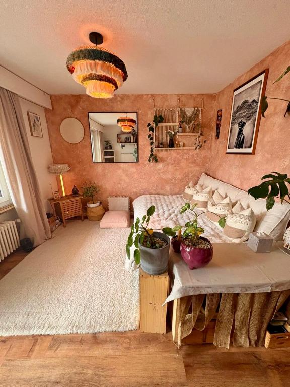 a bedroom with a bed and a table with plants at Layla's in Zermatt