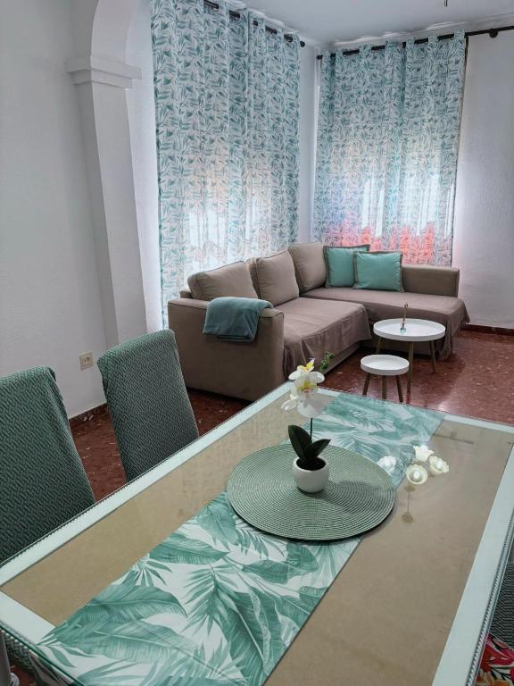 a living room with a couch and a table at Alojamiento rural El Membrillo in Almodóvar del Río