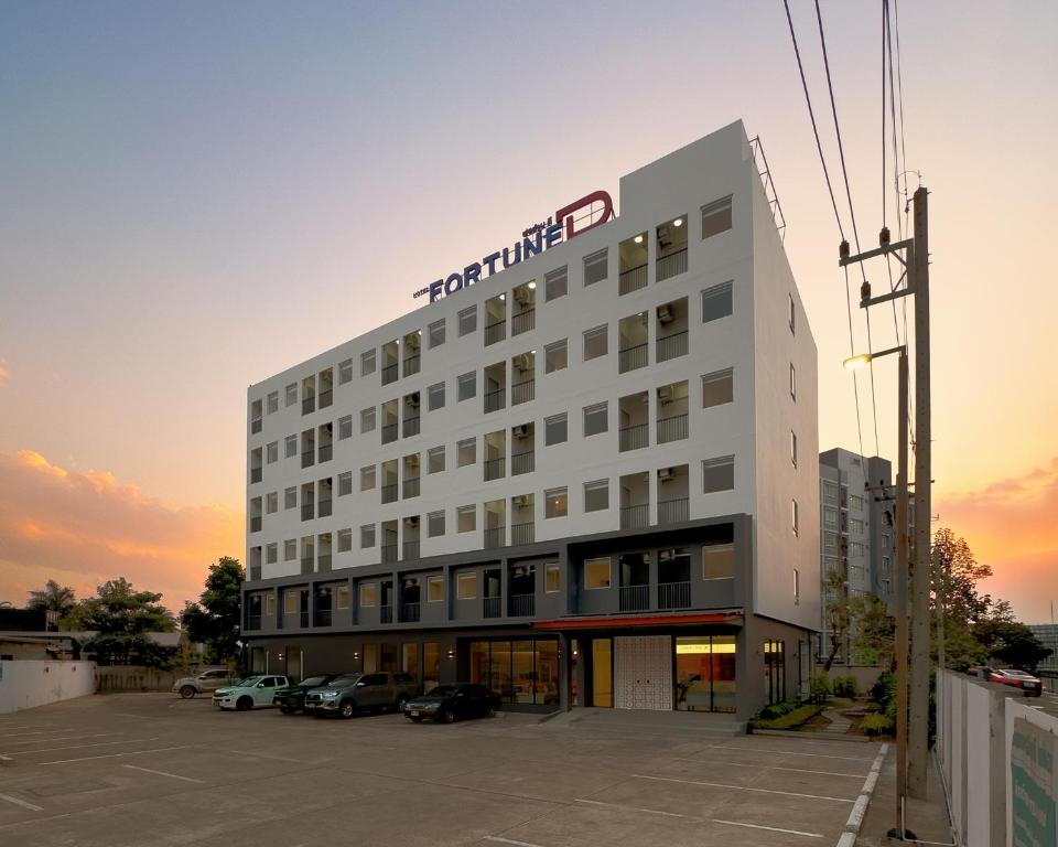 a building with a sign on the side of it at Fortune D Hotel Maesot in Mae Sot