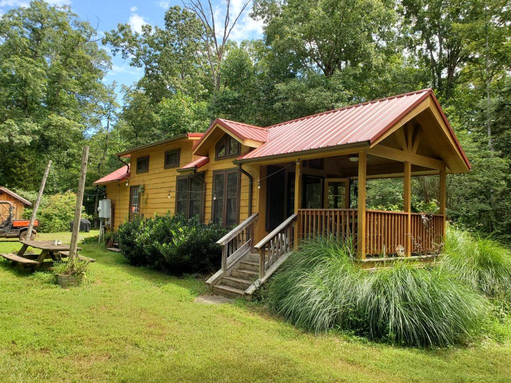 a log cabin with a porch and a deck at Bison Farm - Cabin "Vieja" in Culpeper