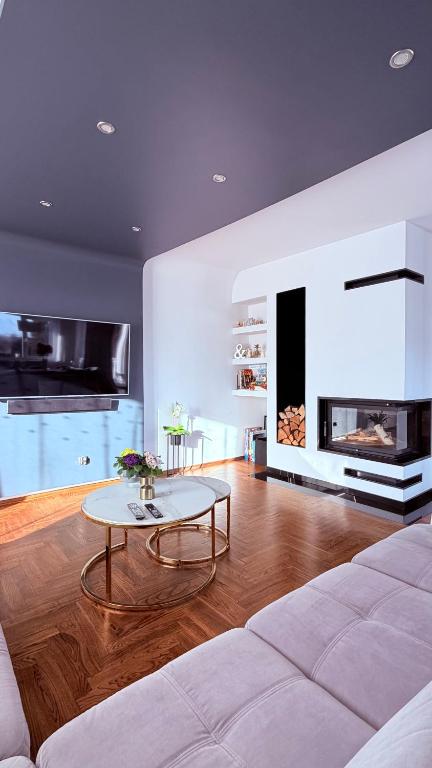 a living room with a white couch and a table at Panorama Apartment in Nowy Targ