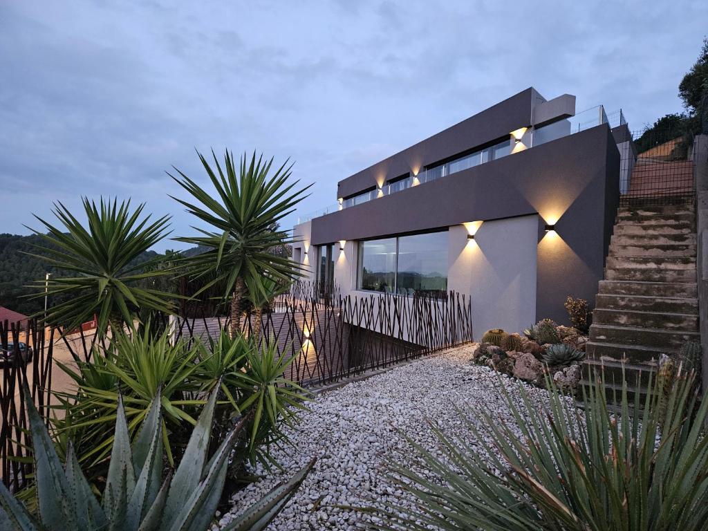 a house with lights on the side of it at Casa Lou, architect villa with heated pool at Begur, 470m2 in Begur