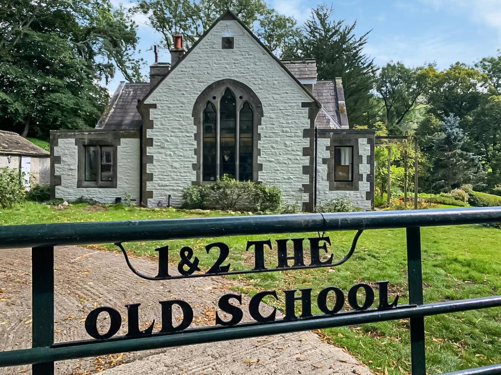 a sign in front of a old school house at The Old School in Kettlewell