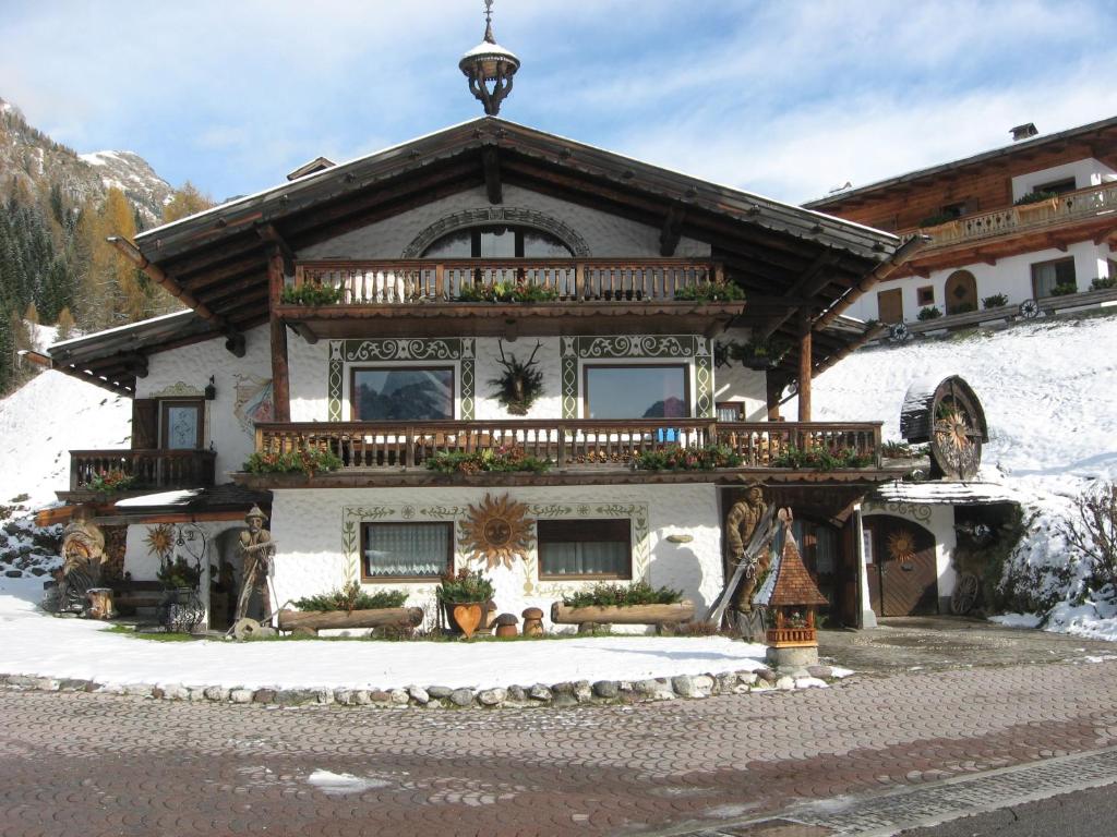 a house in the snow with a balcony on it at bruno piller hoffer in Sappada
