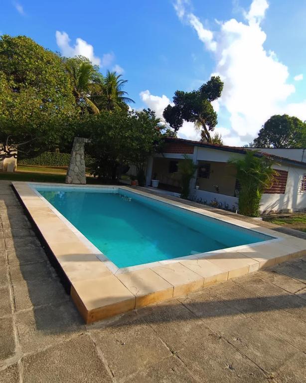 a swimming pool in front of a house at Casa com piscina em Aldeia in Camaragibe